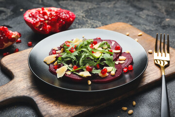 Plate with delicious beetroot carpaccio on dark background
