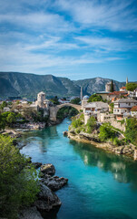 Beautiful view of Mostar city with mosque, ancient buildings and old arch bridge on Neretva river