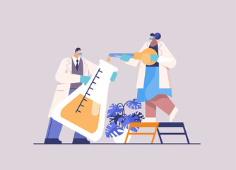 scientist team loading liquid sample in test tube with pipette researchers making chemical experiment