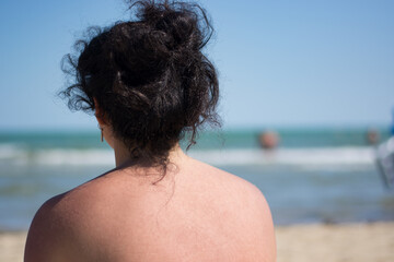 the woman looks at the sea