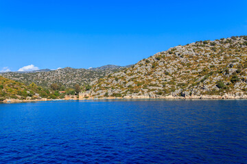 Obraz premium Boats moored at rocky shore of the Mediterranean Sea near Simena in Antalya province, Turkey