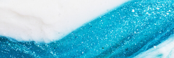 Liquid art gel blue gradient background banner with glitter. Slime toy. Abstract blue and white surface. 