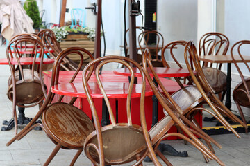 Street cafe with empty tables and folded chairs outdoor, city during coronavirus pandemic
