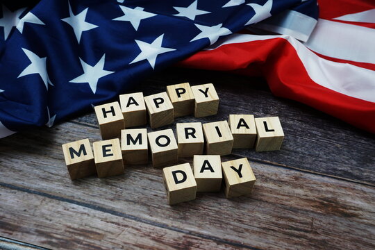Happy Memorial Day Word alphabet letters with USA flag on wooden background