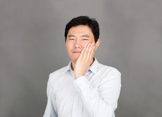 Young man with toothache covering his face