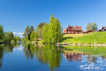 house on a river bank in the Swedish countryside