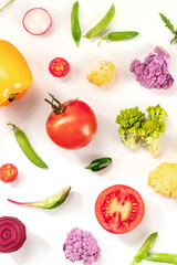 Fresh vegetables flat lay composition on a white background. Tomato, green salad leaves and other healthy vegan products