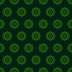 Ethnic pattern is depicted on a green background. Geometric seamless texture.