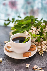 Cup of coffeel and acacia closeup. Nutrition. background with a cup of Coffee and acacia flowers.