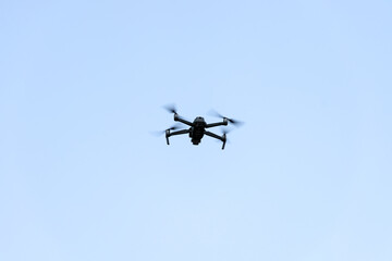 Fototapeta na wymiar Drone quad copter flying with blue sky.