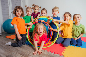 Portrait of smiling children with hula hoops