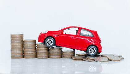 Red miniature car on coin stack : Car loan and leasing time concepts. Car insurance. car model and financial with coins.