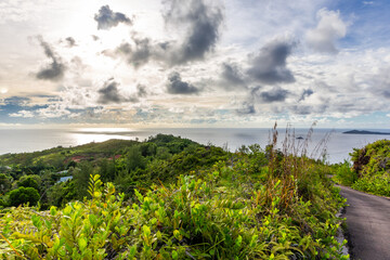 Fototapeta na wymiar Landscape view of Praslin Island, Seychelles, seen from Zimbabwe Point (Grand Fond), with lush tropical vegetation around overlooking the northern side of the island with sea view before sunset.