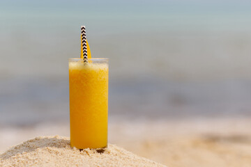 fruit mango cocktail on beach background