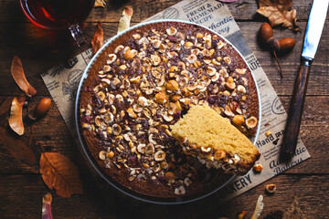 Autumn homemade hazelnut pie on wooden background, mannik pie, top view, horizontal
