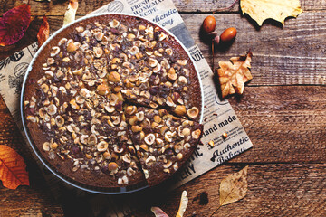 Autumn homemade hazelnut pie on wooden background, mannik pie, top view, horizontal