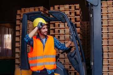 Smiling man posing near industrial stacker forklift at warehouse © oksix