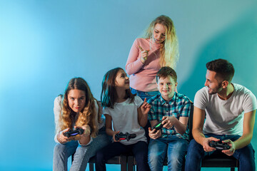 Family holding joysticks and start virtual game