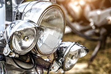 Headlight of the tourist motorcycle.Shiny chrome motorcycle headlights. Close-up. Daylight