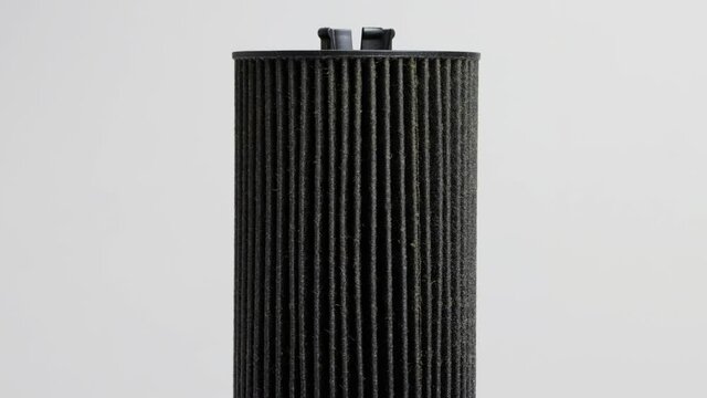 Car oil filter insert on white background. The concept of cleaning oil from dirt and impurities, macro
