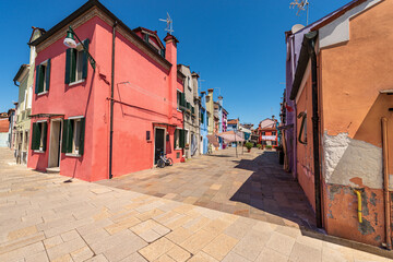 Old small multi colored houses (bright colors) in Burano island in a sunny spring day. Venice lagoon, UNESCO world heritage site, Veneto, Italy, southern Europe.