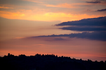 After the sunset, the border between the golden and the blue hour, forest hill silhouette, scenery travel landscape. Beauty in Nature