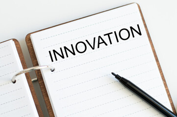 text OF INNOVATION on an open notebook on rings on a white background