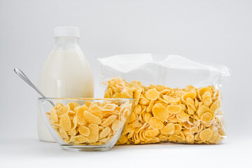 cornflakes with milk in a plate on a white background. dry quick breakfast. american food