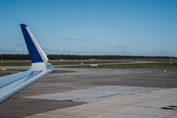 Airplane window view on a wing and runway.