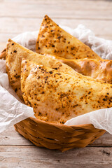 Traditional Chilean empanadas on rustic wooden table	
