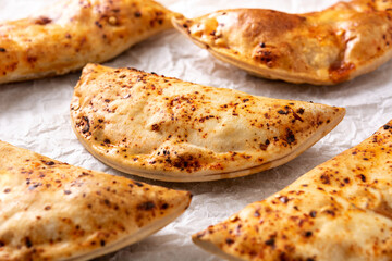 Traditional Chilean empanadas on rustic wooden table	. Close up