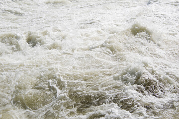 High water current with foam and splashes.