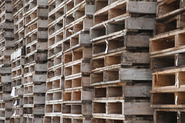 Pile or stack of wooden cargo pallets ready for shipping.