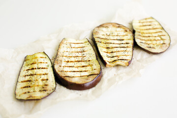 grilled eggplant with spices and garlic on a white background