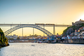 Cityscape of Porto with Douro river and famous bridge by sunset, Portugal