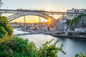 Fototapeta na wymiar Cityscape of Porto with Douro river and famous bridge by sunset, Portugal