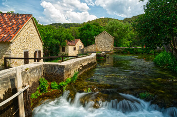 Fototapeta na wymiar Waterfall and historical village in Krka National Park in Croatia, Europe, HDR