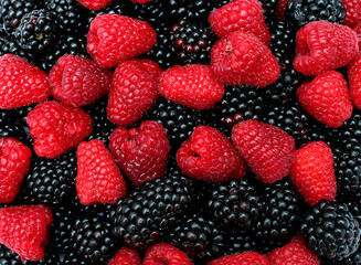 raspberries and blackberries background - obrazy, fototapety, plakaty