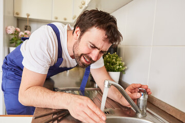 Plumber controls water flow on the tap