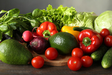 Variety of fresh vegetables pepper, radish, avocado, broccoli, eggplant, cabbage, tomato, red onion on a board