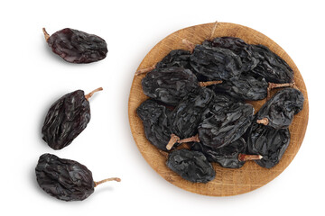 Black raisin iin wooden bowl solated on white background with clipping path. Top view. Flat lay
