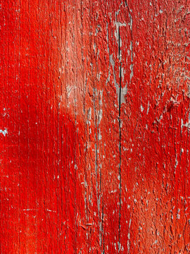 Red peeling paint over cracked wood (backgrounds)