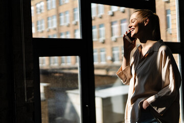 Fototapeta premium Smiling young white woman with blonde hair talking