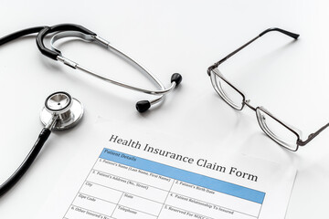 Health insuranse claim form with stethoscope. Medical care concept.