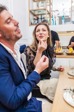 Beautiful stylish woman conversating with friends at a dinner party