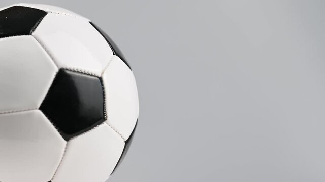 The soccer ball is spinning on a white background