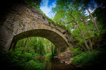 a big stone bridge, river and green forest