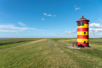 Pilsum lighthouse on the flood dam near Pilsum