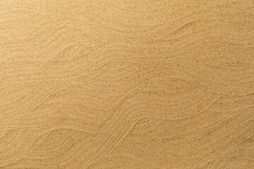 Fototapeta na wymiar The texture of the smooth surface of fine-grained sand