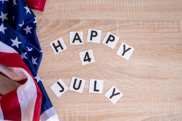 Fototapeta na wymiar Light box with text HAPPY 4 JULY on a dark wooden background. Flat lay. Independence Day USA concept. Greeting card.